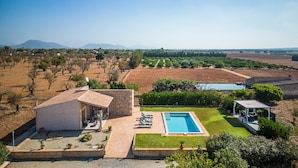 A villa with a swimming pool, a patio with outdoor furniture, and a view of the surrounding landscape. - Finca in Mallorca El Rafal de Son Alberti with pool (Buger)