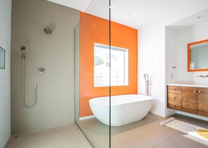 Bathtub, hair dryer, towels, toilet paper