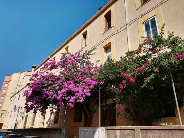 A building with a balcony and a window with a view of the sky.