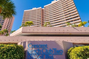A multi-story hotel with balconies and palm trees. - Amazing Beachfront in Crescent Beach Club Gated Community with Sweeping Views! (Clearwater)