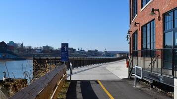 A pedestrian bridge with a wooden fence and a clear view of the river.