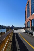 A pedestrian bridge with a wooden fence and a clear view of the river.