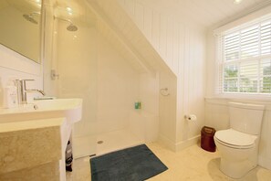 A bathroom with a shower, sink, toilet, and a window with blinds. - Harbourside house with private pool - amazing sea views! (Governor's Harbour)