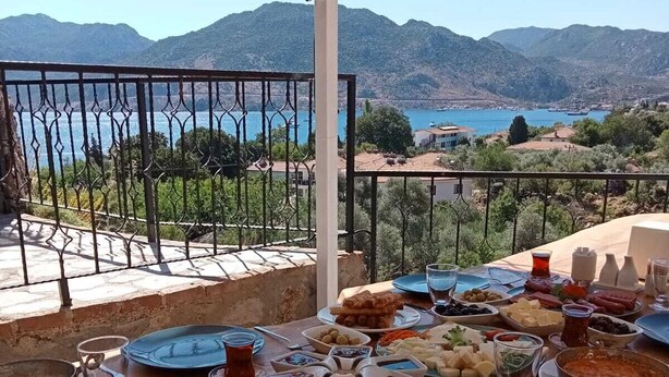 A table set for a meal with a view of the sea and mountains. - Mavi Melek Hotel (Marmaris)