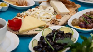 A table set with various cheeses, fruits, and nuts, suggesting a buffet or tasting event. - Mavi Melek Hotel (Marmaris)