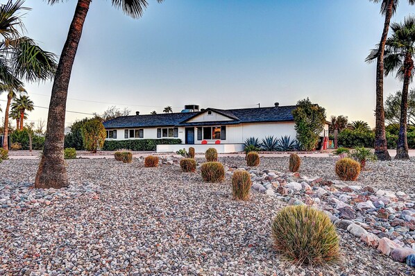 A house with a white exterior, a dark roof, and a front porch. - Scottsdalestays Sleep 22 Multimillion Acre Resort-Big Pool, Spa-Best Area/Yard. (Scottsdale)