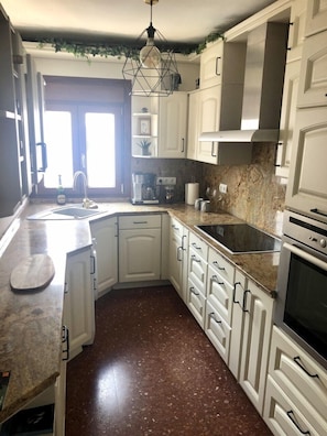 Kitchen features a dishwasher, stainless steel sink, and double oven.