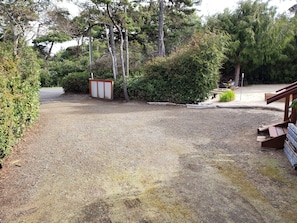 Guests can park their vehicles in the designated area near the building.