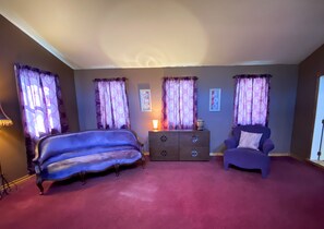 A room with a bed, two armchairs, a dresser, and a lamp. - Spacious & secluded grand home near Kickapoo River, Bike Trails, & ATV routes (Norwalk)