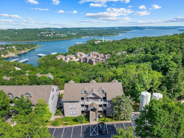 A residential area with houses, a parking lot, and a lake with boats.