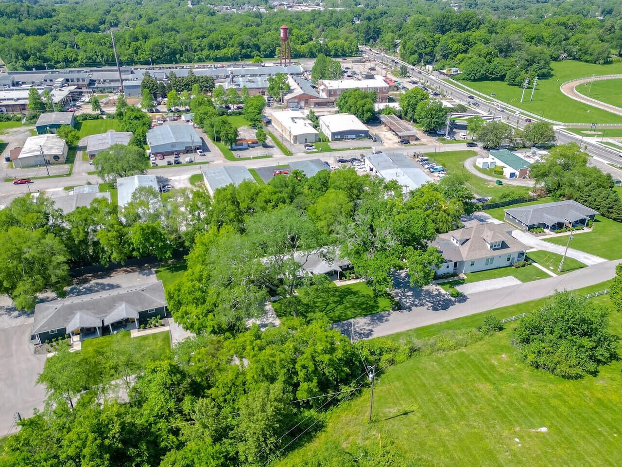 An aerial view of a residential area with houses, roads, and a water tower.