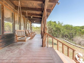Relax on the porch with a serene view of the surrounding landscape.