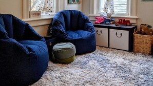 A cozy room with two bean bags, a playroom sign, and a window with polka dot curtains. - Family Friendly FULL HOUSE (Warren)