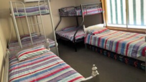 A dormitory room with bunk beds, a window with blinds, and a radiator. - Hidden Oasis on Piper.  Park your car and walk to everything (Yarrawonga)