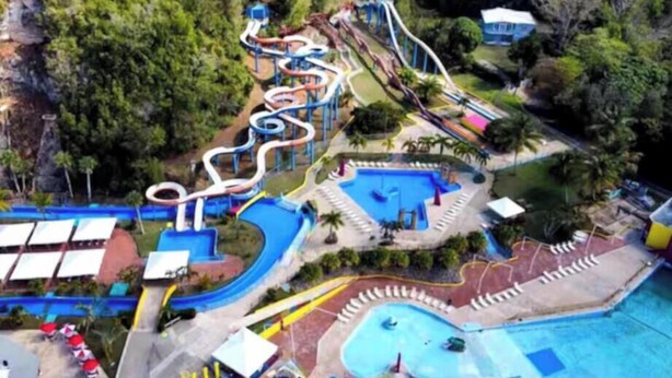 An aerial view of a water park with multiple slides and pools. - Gated condo, pool, high speed Wi-fi, washer & dryer. Walk to beach, near town  (Rincon)