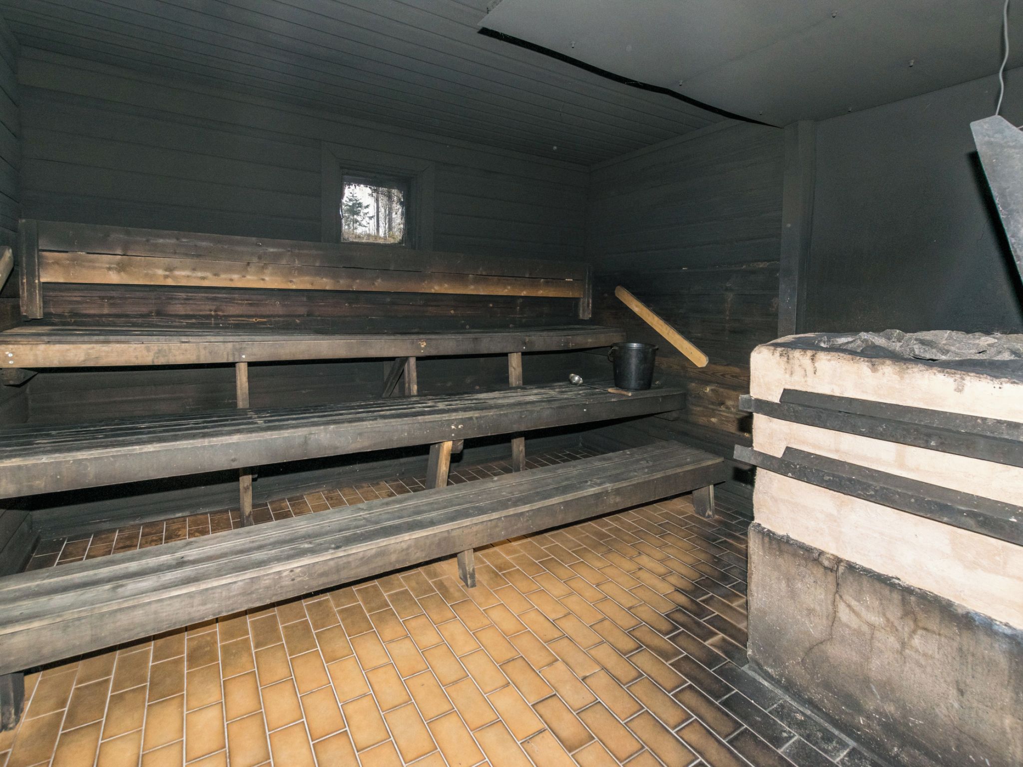 A room with wooden benches and a tiled floor.