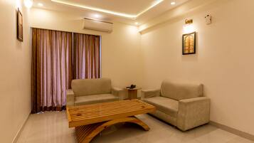 Family Quadruple Room | Living area | 24-inch LED TV with satellite channels, TV, fireplace