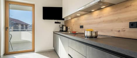 Fridge, stovetop, dishwasher, coffee/tea maker
