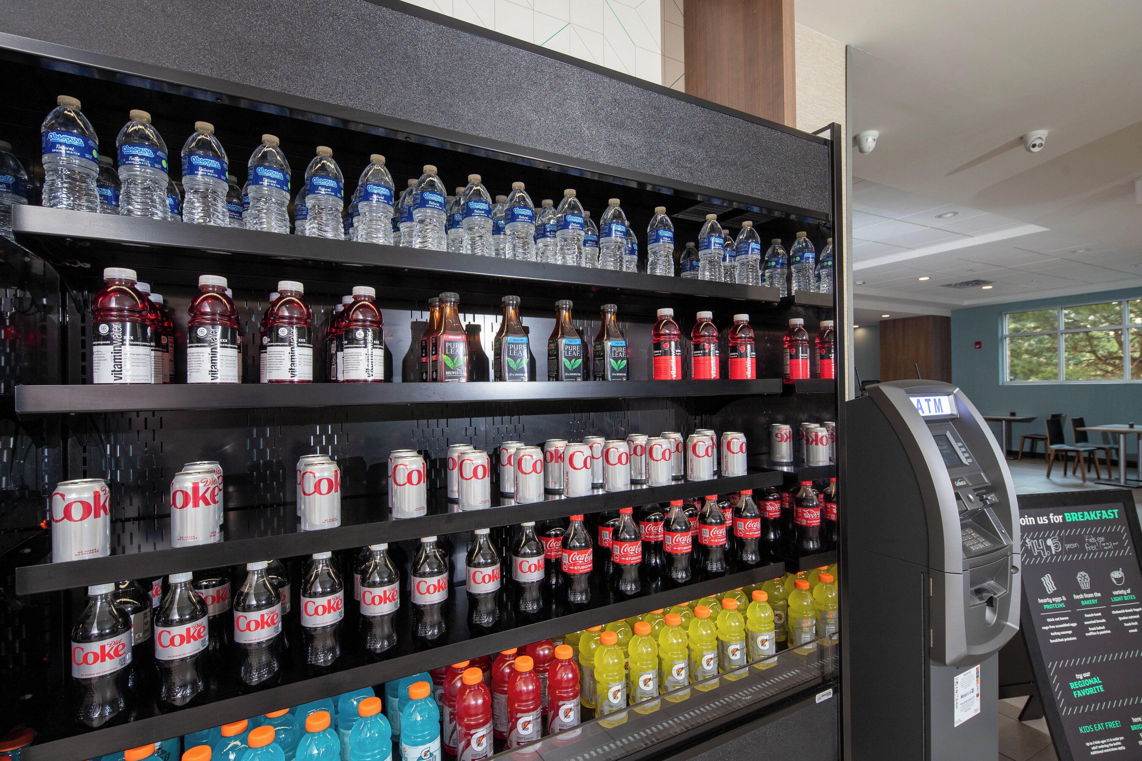 A beverage display with various drinks including water, soda, and energy drinks.