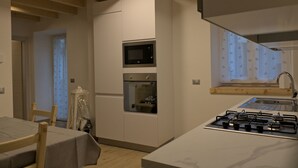 A modern kitchen with a built-in microwave, oven, and gas stove.