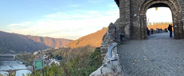 A stone archway leading to a cobblestone path with a view of a river and hills in the background. - 1 Bedroom Private vacation home in Bremm (Bremm)