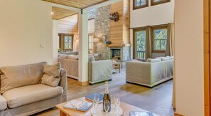 Relax in this cozy living area with a stone fireplace, two sofas, and a coffee table.