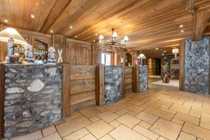A wooden interior with stone walls and a reception desk.