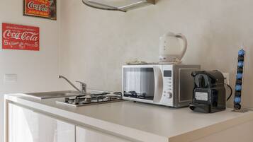Business Apartment | Private kitchen | Mini-fridge, electric kettle, cookware/dishes/utensils, dining tables