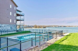 Enjoy a refreshing swim in the pool overlooking the serene lake.