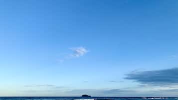 Enjoy a serene coastal escape with gentle waves lapping at the shore.
