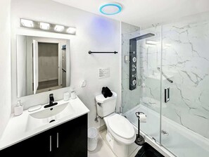 Shower, hair dryer, towels, shampoo