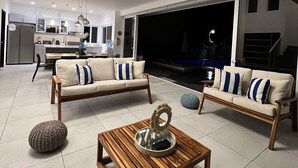 A spacious living area with a sofa set, a coffee table, and a dining area in the background. - Lazo Beach House, Costa del Sol (San Luis, La herradura)