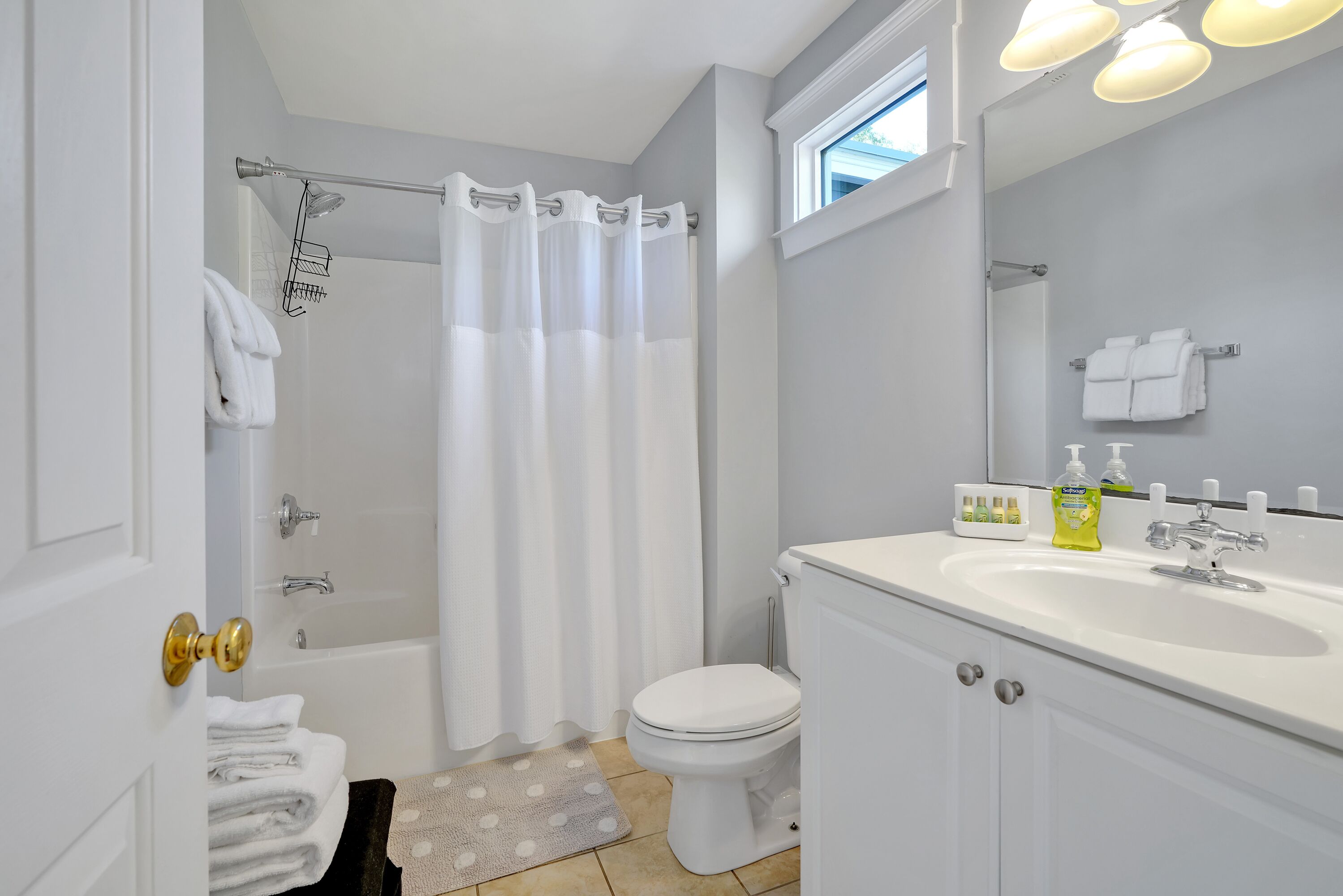 A bathroom with a bathtub, toilet, and sink.