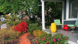 A garden pathway with red brick edging, surrounded by various shrubs and flowers. - Manhattan on Front! Balcony Park Free! (Wilmington)