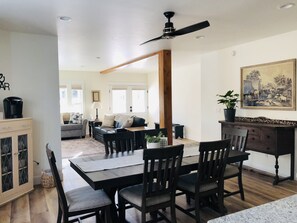 A dining area with a wooden table, chairs, and a ceiling fan. - Luxury on Main, remodeled, homey, fresh and bright! (Bozeman)