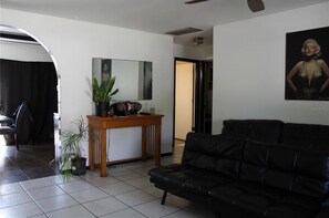 Relax in this stylish living room with a comfortable sofa, console table, and potted plant.