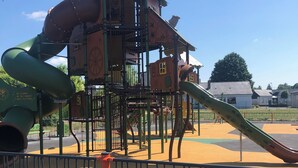 Un parque infantil con tobogán y estructuras para escalar.