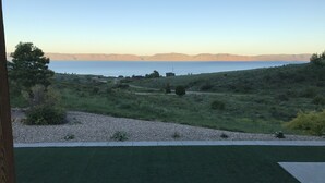 A grassy area with a view of the sea and distant mountains. - Bear Lake Cabin w/ lots of privacy and amazing Lake View (Fish Haven)