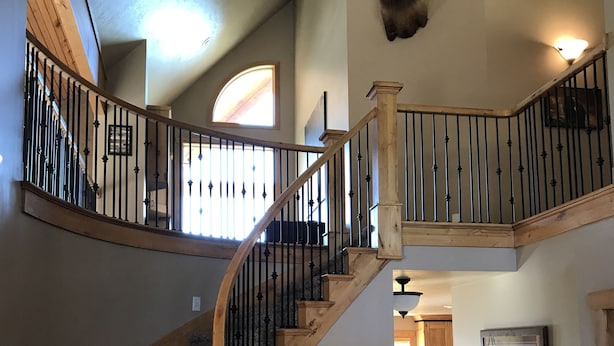 A multi-level staircase with wooden railings and carpeted steps. - Bear Lake Cabin w/ lots of privacy and amazing Lake View (Fish Haven)