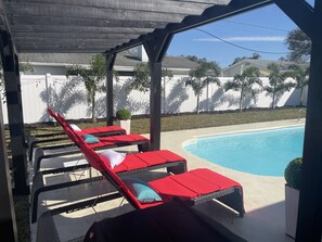 Outdoor pool, a heated pool - ☀️WOW☀️ UPDATED with HEATED POOL & HOT TUB HOME 5 MIN TO BEACH 3BD 2BA 2 KING BEDS (Seminole)