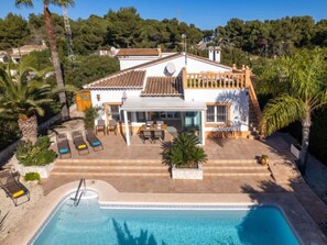 A white villa with a tiled roof, a swimming pool, and outdoor seating. - Harmony by Interhome (Jávea)