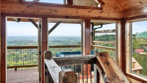 A wooden cabin with a balcony overlooking a scenic landscape. - Near Dollywood! Beautiful Mountain Views, Hot Tub & Resort Indoor Heated Pool (Sevierville)