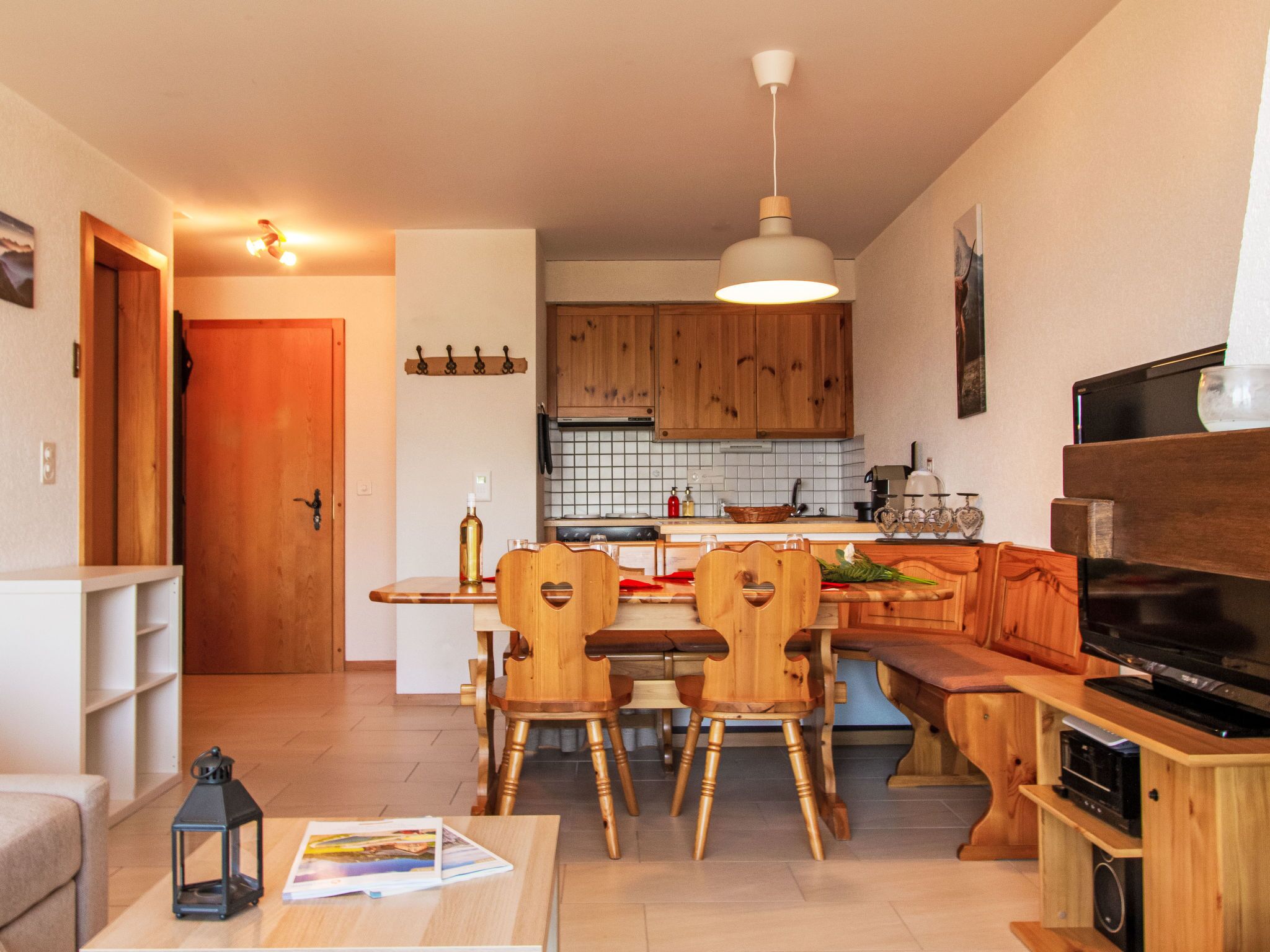 Un espace de vie compact comprenant un coin repas, une cuisine et un coin salon.
