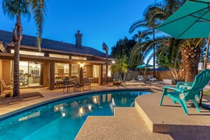 A swimming pool with a patio area, lounge chairs, and a building with a covered patio. - Golf Course VIEW: Htd POOL, Hot Tub, Fire Pit, Game Room w/Pool Table, TVs All BRs, 2 Kid's Bikes (Gilbert)