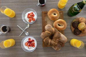 A breakfast table with various food items and drinks. - Chic and Sunny in the Heart of Tel Aviv (Tel Aviv)