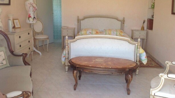 A bedroom with a bed, two nightstands, a dresser, a chair, and a mirror. - Lilac room (Saint-Didier-de-la-Tour)
