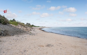 Enjoy a serene beach experience with access to the ocean and a scenic staircase leading down to the shore.