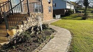 A brick building with a stone staircase and a paved walkway leading to the entrance. - Guest suite (Chattanooga)