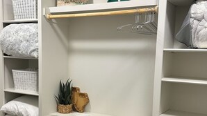 A white closet with shelves, a wooden rod, and a hanging rack. - Relaxing Lubbock Studio ~ 6 Mi to Texas Tech (Lubbock)