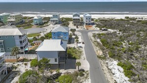 A coastal residential area with multiple two-story houses, a beach in the background, and a clear sky. - Fond Horizons: Beach View, Private Pool, Pet Friendly! (Cape San Blas)